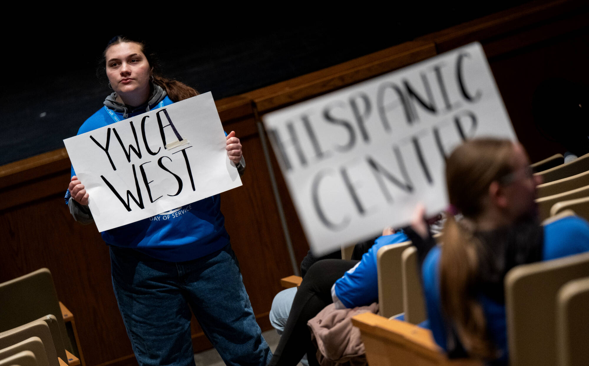 student holding site signs